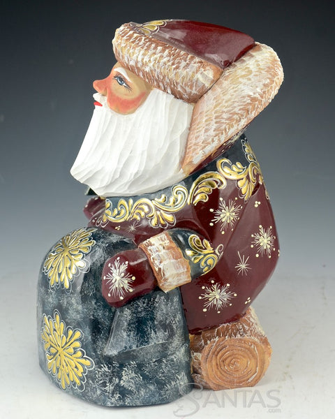 Burgundy and Gold Carved Russian Santa Sitting on a Log